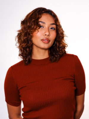 Profile picture of artist Sienna Gonzales in a red shirt. 